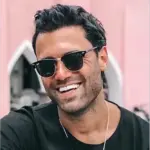 Thubnail of a smiling man with full hair and sunglasses after hair restoration